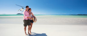 Couple on Whitehaven Beach, Australia, with Helicopter